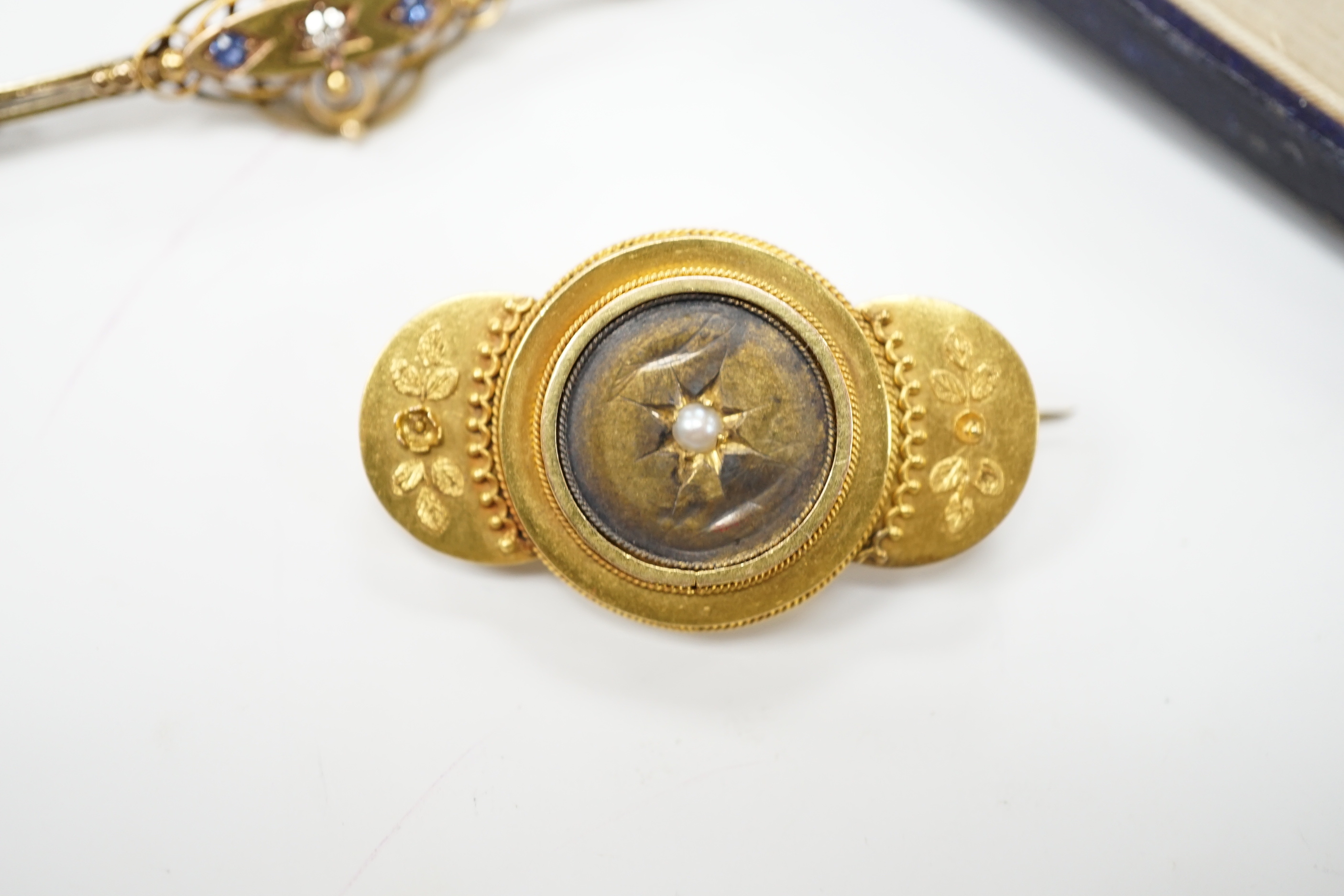 An Edwardian 15ct, sapphire and diamond set three stone bar brooch, 48mm, a later 14ct gold enamel and baroque pearls set 'Kingfisher' bar brooch, one other yellow metal and seed pearl set brooch and an Edwardian 15ct an